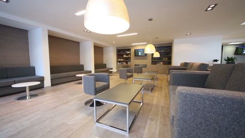 Rest-room with sofas, tv and bookcases at modern business center