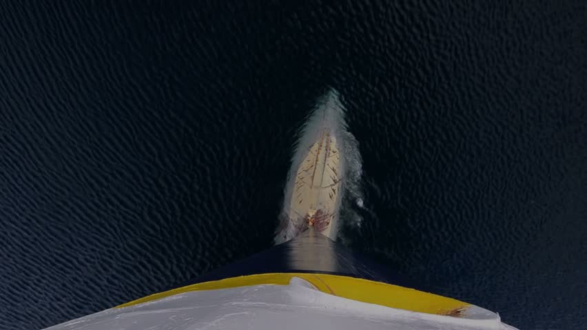 Tilt up bulbous bow point of view of an icebreaker ship plowing through sea ice in Hinlopen Strait in Svalbard Archipelago, Norway.