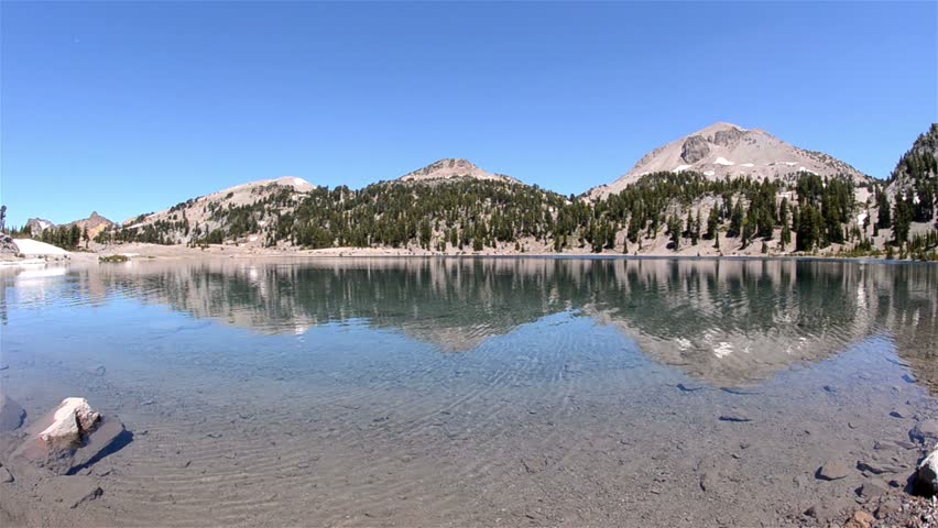 Clear blue water of Lake Helen below Eagle Peak in Lassen Volcanic National Park, California.