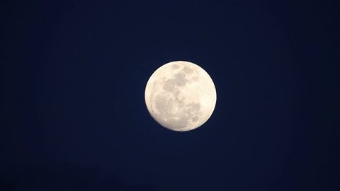 Стоковое видео: A full moon rises.