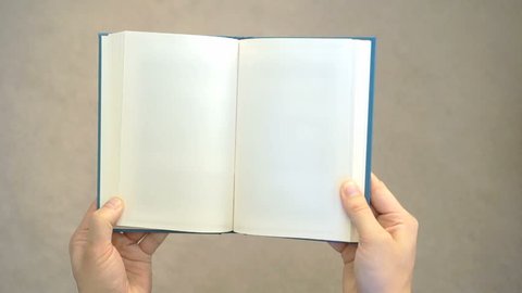Two hands opening a blank book. Can be used as a blank template. Holding the book with two hands, it is opened and then closed.