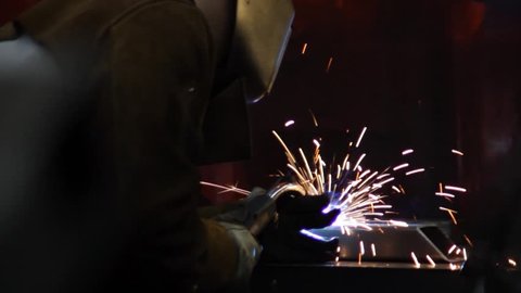 Welder with Sparks Flying, Dolly Shot to Reveal