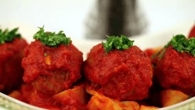 Meatballs Parmesan - Stock footage of grating parmesan above hot meatballs and pasta.