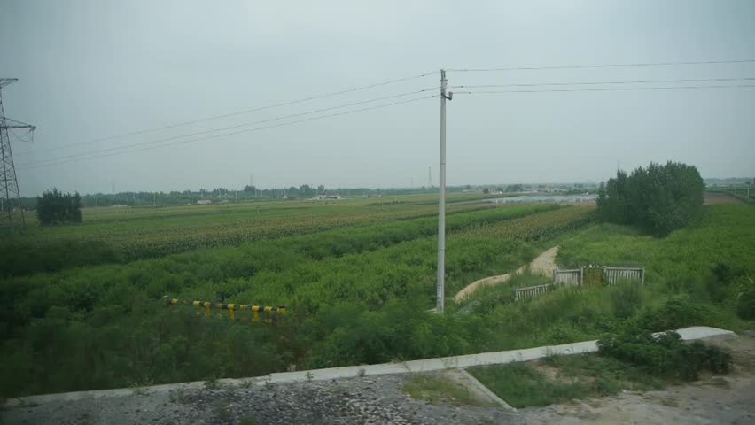 Villages plains tree crops farmland in rural countryside.Speeding train travel,scenery outside window. gh2_03025