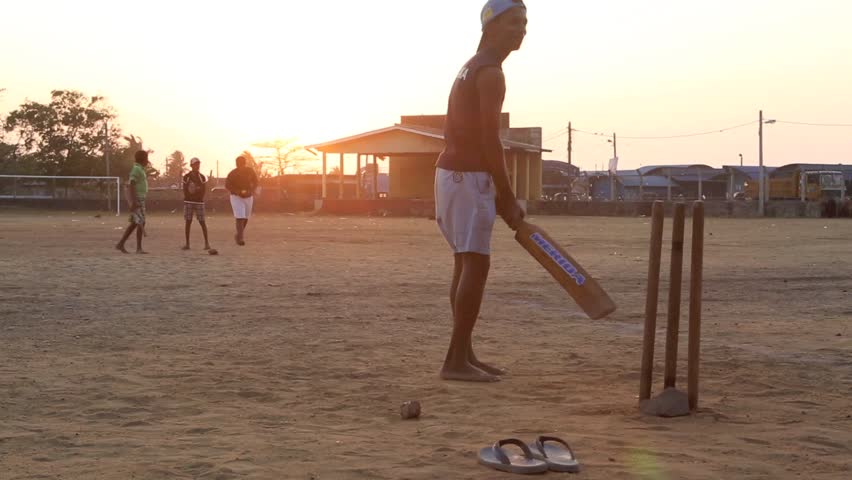 NEGOMBO, SRI LANKA - FEB 22: Teenage boys playing casual game of cricket using tennis ball at sunset on February 22, 2014 in Negombo, Sri Lanka | Shutterstock HD Video #6045848