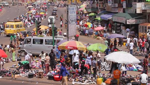 KUMASI, GHANA AFRICA  - MAY 2013, camera pans, people buying in selling
