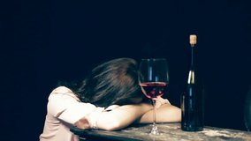 Young woman drinking red wine alone.