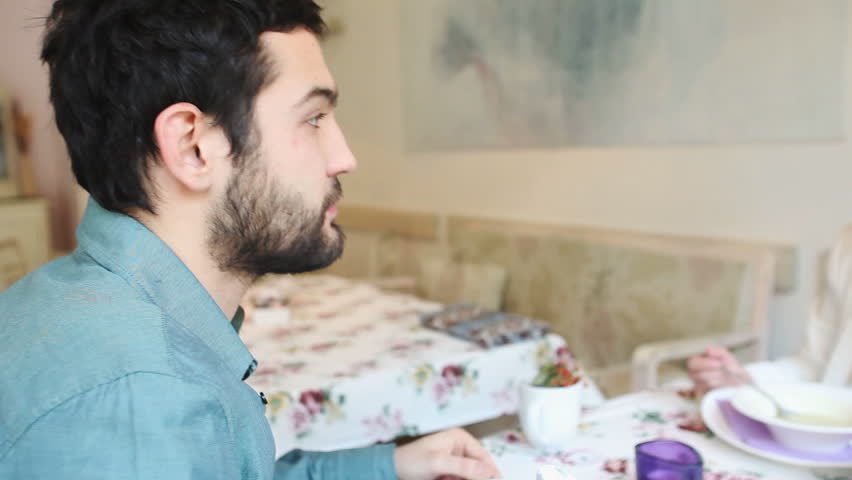Handsome young man eating in soup a restaurant