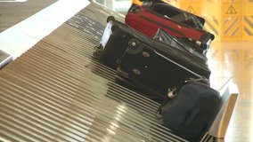 Airport luggage bags on terminal at passenger pick up area. HD High Definition stock video footage clip 1920x1080