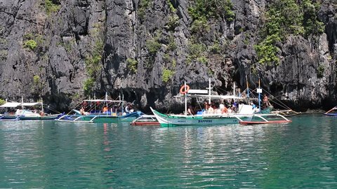 EL NIDO, PHILIPPINES - FEBRUARY 04, 2014 : Boats together tourists to travel between the islands. El Nido is one of the top tourist destinations in the world.