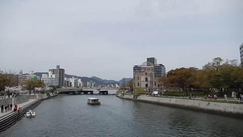 HIROSHIMA, JAPAN - APRIL 1: A-Bomb Dome and the Ota River on April 1, 2014, Hiroshima, Japan. A-Bomb Dome is the memory of the nuclear attack against the city. 