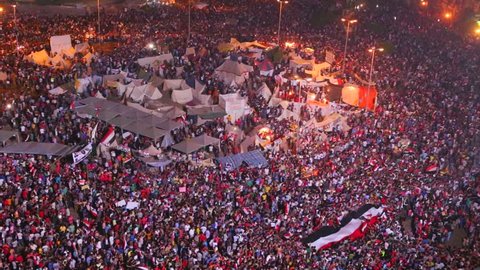 Overhead view as protestors jam Tahrir Square in Cairo, Egypt at a large nighttime rally.