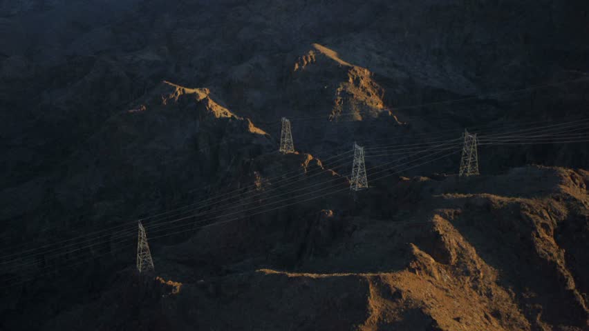 Aerial view of powerlines snaking through the mountains near the Hoover Dam.