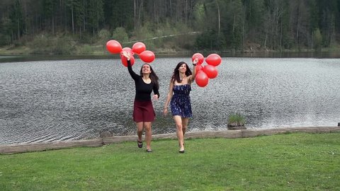 Young Women And Red Balloons At Lake