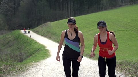 Two Girls Relaxing Muscles After Long Run In Slow Motion