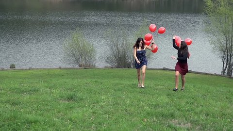 Girls With Red Balloons Running Uphill in Slow Motion