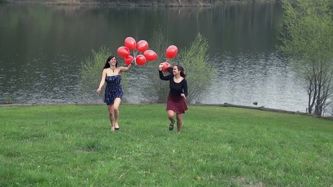 Beautiful Ladies Running Towards Camera With Red Balloons
