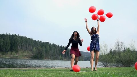 Throwing A lot Of Red Balloons In To Air In Nature