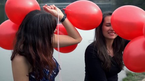 Two Elegant Ladies With Red Balloons At Lake Enjoy Life