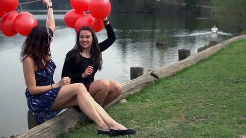 Slow Motion Two Girls With Red Balloons At Lake