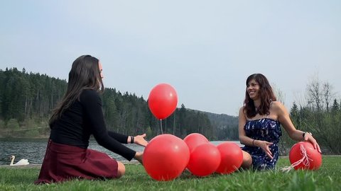 Playing With Red Balloons At Lake in Slow Motion