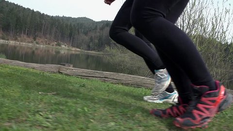 Side Shot Of Two Runners At Lake In Slow Motion