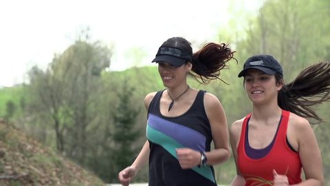 Two Girls Running Up Hill In Slow Motion