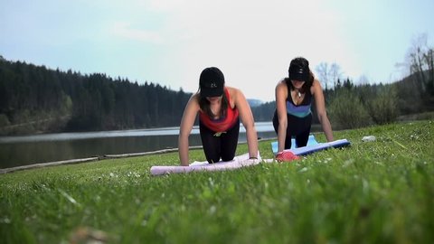 Smiling Fit Friends Doing Push-ups Exercising in Nature