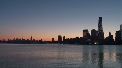 The Freedom Tower, part of the new World Trade Center complex, rises over the skyline of lower Manhattan looking north up the Hudson River toward midtown during morning twilight in New York City.