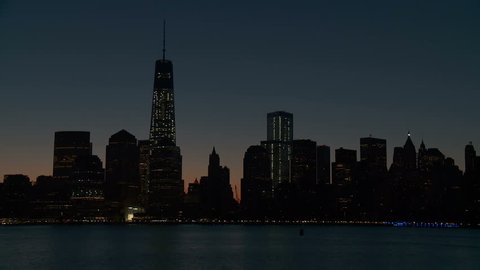 The Freedom Tower, part of the new World Trade Center complex, rises over the skyline of lower Manhattan during morning twilight in New York City.