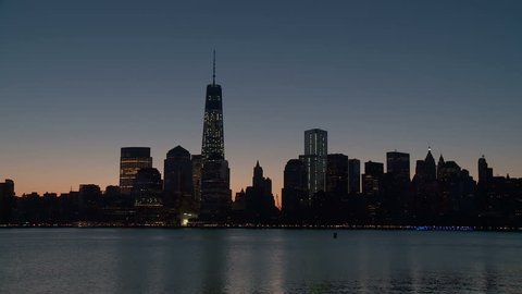 The Freedom Tower, part of the new World Trade Center complex, rises over the skyline of lower Manhattan during morning twilight in New York City.