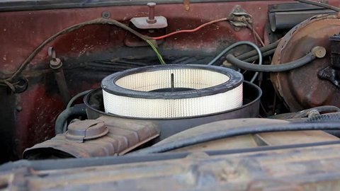 Small Amount Of Gasoline Poured Quickly Down An Open Air Filter Housing Of An Old Vehicle