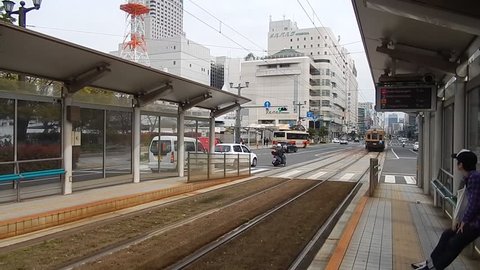 HIROSHIMA, JAPAN - APRIL 1: Train arriving at station at April 1, 2014 in Hiroshima, Japan. Hiroshima is on e of the few cities in Japan where there are trams for public transport.