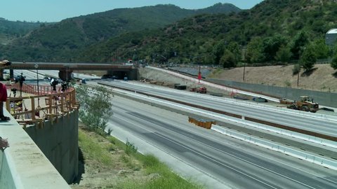 LOS ANGELES, CALIFORNIA, CIRCA 2013 - Pan left to right over an empty stretch of the 405 freeway in Los Angles as crews tear down part of a bridge.