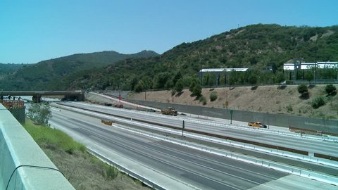LOS ANGELES, CALIFORNIA, CIRCA 2013 - Pan left to right over an empty stretch of the 405 freeway in Los Angles as crews tear down part of a bridge.