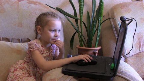 girl playing in a laptop holding hands mouse