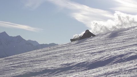 Snowboarding in mountains. Extreme carving.  Slow motion.