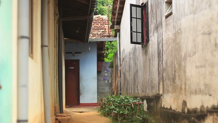 Hambantota, Asia, Sri Lanka, in November 2013. Poor neighborhoods. Bright colors of the buildings, interesting architecture. Traffic on the narrow streets.