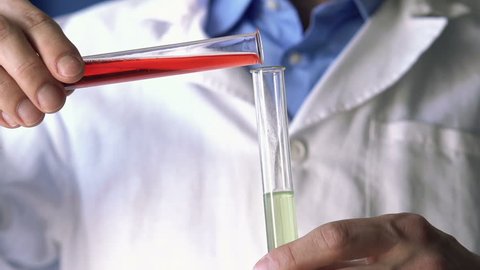 Chemist mixing chemicals in test tubes, super slow motion, shot at 240fps
