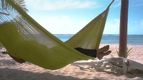 Sleeping in hammock on caribbean beach at Mahahual, Quintana roo, Mexico