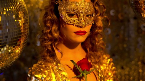 beautiful sexy female in fantastic gold catsuit in lounge bar setting with mask and a rose. Useful for parties, clubs and events
 Stockvideo