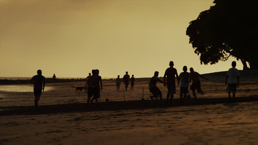 Slow motion, medium shot of people playing outdoors at night / Esterillos Beach, Costa Rica