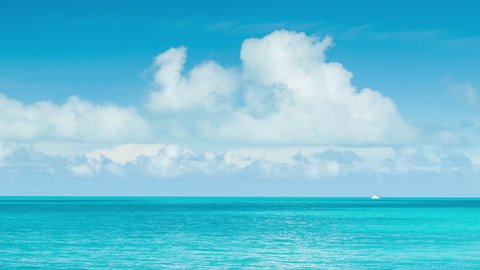Little White Boat on Vast Tropical Ocean Waters in Bermuda with a Blue Sky Full of White Clouds on a Sunny Day.
