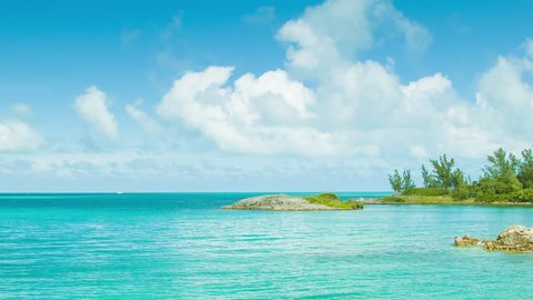 An Exotic Island Setting in Tropical Waters, with Turquoise Colored Water, Lush Green Foliage and a Blue Sky with White Clouds on a Sunny Day in Bermuda.