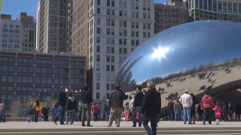 CHICAGO, USA - APRIL 17, 2013, Pan right of tourist people visit The Bean, Cloud Gate in summer day  