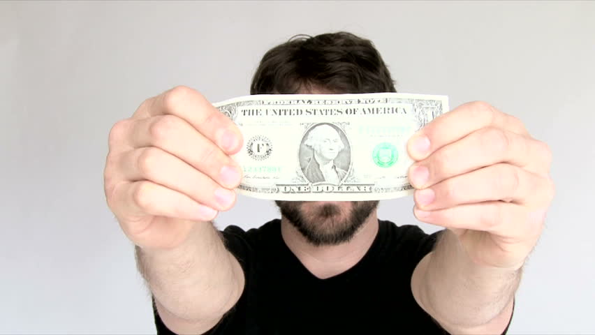 Model released man in studio with a crisp one dollar bill. | Shutterstock HD Video #6076607