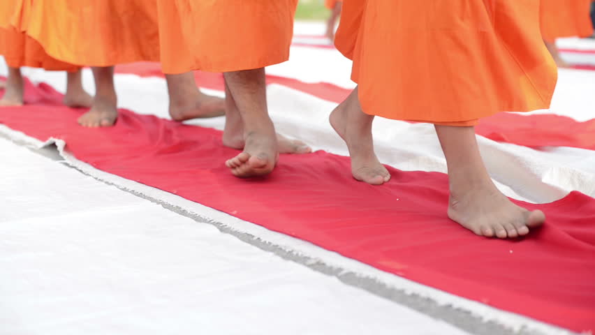 group of monk buddhist walking on fabric red line 