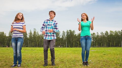 Teens Dancing in a Meadow, a young man and a young woman having fun