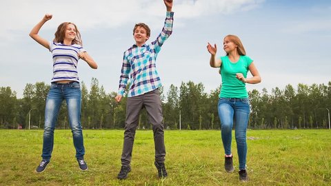 Teens Dancing in a Meadow, a young man and a young woman having fun