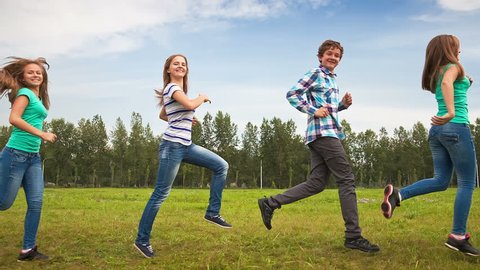 Teens Running Through the Meadow, young people having fun (looped)
